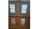 Spacious bedroom boasting hardwood floors and natural light from two windows at 4845 Weathervane Dr, Alpharetta, GA 30022