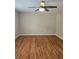An expansive bedroom features hardwood floors, ceiling fan, and neutral paint at 4845 Weathervane Dr, Alpharetta, GA 30022