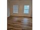 Bright bedroom with wood floors and two windows at 4845 Weathervane Dr, Alpharetta, GA 30022
