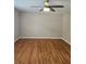 An expansive bedroom features hardwood floors, ceiling fan, and neutral paint at 4845 Weathervane Dr, Alpharetta, GA 30022