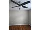 Simple bedroom featuring hardwood floors and a ceiling fan at 4845 Weathervane Dr, Alpharetta, GA 30022