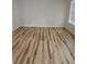 Bright room with hardwood flooring and natural light from a large window at 4845 Weathervane Dr, Alpharetta, GA 30022