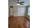 Spacious bedroom featuring hardwood floors, double closets, and a ceiling fan at 4845 Weathervane Dr, Alpharetta, GA 30022