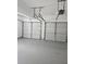 Spacious garage with freshly painted floor and automatic door openers at 4845 Weathervane Dr, Alpharetta, GA 30022