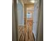 Inviting hallway with wood floors leading to a dining room with chandelier at 4845 Weathervane Dr, Alpharetta, GA 30022