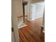Upstairs hallway featuring hardwood floors and views into other rooms at 4845 Weathervane Dr, Alpharetta, GA 30022