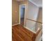 Hallway overlooking the home's staircase and with views of the main bedroom at 4845 Weathervane Dr, Alpharetta, GA 30022