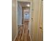 Inviting hallway with wood floors leading to a dining room with chandelier at 4845 Weathervane Dr, Alpharetta, GA 30022