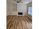 Cozy living room with fireplace, built-in shelving, and beautiful hardwood floors at 4845 Weathervane Dr, Alpharetta, GA 30022