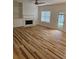 Living room featuring wood floors, fireplace and a door leading to backyard at 4845 Weathervane Dr, Alpharetta, GA 30022
