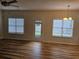 Living room featuring wood floors, ceiling fan and a door leading to backyard at 4845 Weathervane Dr, Alpharetta, GA 30022