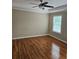 Spacious main bedroom featuring hardwood floors, tray ceiling, and a bright window at 4845 Weathervane Dr, Alpharetta, GA 30022