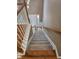 Staircase with carpeted steps and wooden banisters leading to the home's front door at 4845 Weathervane Dr, Alpharetta, GA 30022