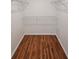 Empty walk-in closet featuring hardwood floors and wire rack shelving at 4845 Weathervane Dr, Alpharetta, GA 30022