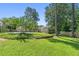 Expansive backyard with lush green lawn, mature trees, and partial fencing for added privacy at 1444 Arden Sw Dr, Marietta, GA 30008