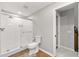 Bright bathroom features a glass-enclosed shower, wood-look floors, and a modern toilet at 1444 Arden Sw Dr, Marietta, GA 30008