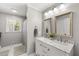 Bathroom featuring double sinks, elegant mirrors, and modern fixtures, creating a spa-like retreat at 1444 Arden Sw Dr, Marietta, GA 30008