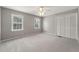 Spacious bedroom with neutral carpet, multiple windows for natural light, and a large closet at 1444 Arden Sw Dr, Marietta, GA 30008