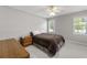 Bright bedroom featuring plush carpet, a cozy bed, and natural light from the surrounding windows at 1444 Arden Sw Dr, Marietta, GA 30008