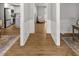 Hallway with wood floors leads to an open kitchen and other living spaces at 1444 Arden Sw Dr, Marietta, GA 30008