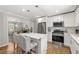 Modern kitchen with stainless steel appliances, a central island, and stylish pendant lighting at 1444 Arden Sw Dr, Marietta, GA 30008