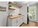 Bright laundry room with wooden accents, modern washer and dryer, and a window for natural light at 1444 Arden Sw Dr, Marietta, GA 30008