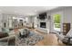 Cozy living room with fireplace, open to the kitchen, with a comfortable sofa and natural light at 1444 Arden Sw Dr, Marietta, GA 30008