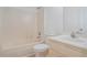 Neutral bathroom featuring a tub-shower combo, a white toilet and a neutral vanity at 1721 Druids Se Xing, Conyers, GA 30013