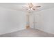 This bedroom features neutral carpet, a ceiling fan and two entry doors at 1721 Druids Se Xing, Conyers, GA 30013