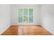 Bedroom with refinished hardwood flooring and a view to the outdoors at 1721 Druids Se Xing, Conyers, GA 30013
