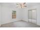 This bedroom features plush carpets, a ceiling fan and mirrored closet doors at 1721 Druids Se Xing, Conyers, GA 30013