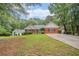 A well-maintained single-Gathering home with a lush green lawn and tree-lined surroundings at 1721 Druids Se Xing, Conyers, GA 30013