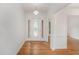 Bright entry with hardwood floors and a decorative front door featuring sidelights at 1721 Druids Se Xing, Conyers, GA 30013