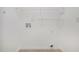 Bright laundry room with washer/dryer hookups and open shelving for easy organization at 1721 Druids Se Xing, Conyers, GA 30013