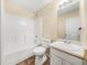 Well-lit bathroom featuring a tub-shower combo and a large mirror over the vanity at 5718 Hidden Brook Cir, Atlanta, GA 30349
