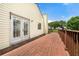 Outdoor deck with a wood railing and French door access to home, great for entertaining at 5718 Hidden Brook Cir, Atlanta, GA 30349