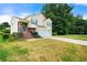 Well-kept home with a two-car garage, brick-accented entry, and a green lawn at 5718 Hidden Brook Cir, Atlanta, GA 30349