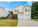 Charming two-story home featuring a two-car garage, brick accents, and a well-maintained front yard at 5718 Hidden Brook Cir, Atlanta, GA 30349