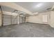 A spacious garage with a concrete floor, white walls, and two functional garage doors at 5718 Hidden Brook Cir, Atlanta, GA 30349