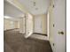 Hallway with neutral walls and access to multiple rooms at 5718 Hidden Brook Cir, Atlanta, GA 30349