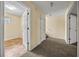 Hallway featuring entrances to carpeted and tiled rooms at 5718 Hidden Brook Cir, Atlanta, GA 30349