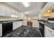 Open kitchen featuring a gas range and views to the dining and living spaces at 5718 Hidden Brook Cir, Atlanta, GA 30349
