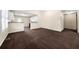 Spacious living room with dark carpet and an open layout to the kitchen at 5718 Hidden Brook Cir, Atlanta, GA 30349