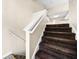 Carpeted staircase with white railing leading to the upper level of the home at 5718 Hidden Brook Cir, Atlanta, GA 30349