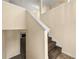 Carpeted staircase with white trim and a view into the living room at 5718 Hidden Brook Cir, Atlanta, GA 30349