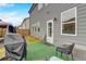 Backyard patio area with patio furniture under a canopy, grill, and a door leading into the house at 7246 Gladstone Cir, Lithonia, GA 30038