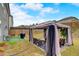 Outdoor backyard space with a canopy, patio furniture, and well-maintained green grass, perfect for outdoor relaxation at 7246 Gladstone Cir, Lithonia, GA 30038