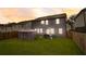 Spacious backyard with well-maintained grass, a gazebo, and a privacy fence at 7246 Gladstone Cir, Lithonia, GA 30038