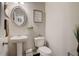 Powder room with pedestal sink, oval mirror, and neutral decor at 7246 Gladstone Cir, Lithonia, GA 30038
