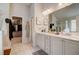 Elegant bathroom featuring double sinks, generous vanity space, walk-in closet, and separate shower at 7246 Gladstone Cir, Lithonia, GA 30038